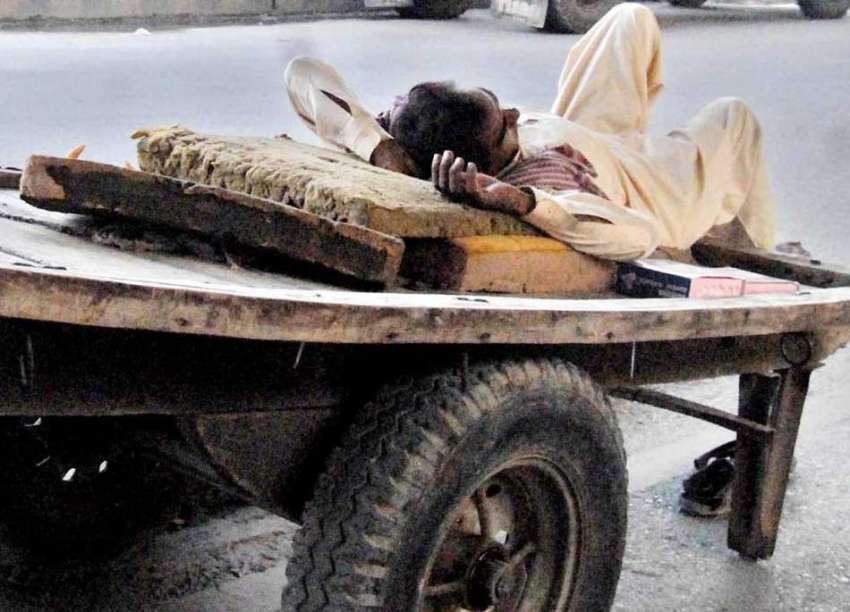 راولپنڈی: محنت کش دن بھر کی تھکاوٹ کے بعد اپنے ریڑھے پر آرام ..