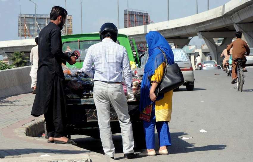 راولپنڈی: مری روڈ پر اسٹال سے ایک خاندان جوتا خرید رہا ہے