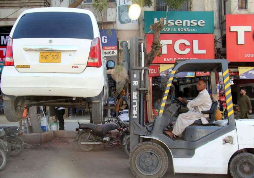 کراچی، صدر میں نوپارکنگ سے کار کو لفٹر سے اُٹھایا جا رہا ..